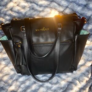 White Elm Gemini Convertible Backpack in black vegan leather with an aqua lining